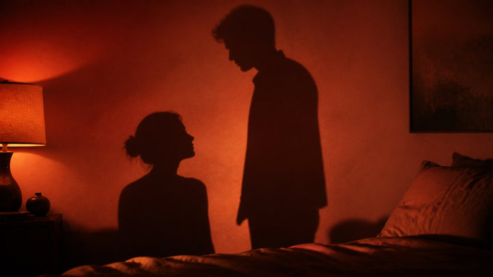 Dramatic silhouette of a couple as long shadows on a warm terracotta bedroom wall, piledriver sex position guide
