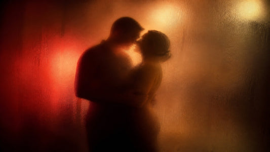 Silhouettes of a couple embracing behind frosted glass in warm red-gold light, closed missionary position guide