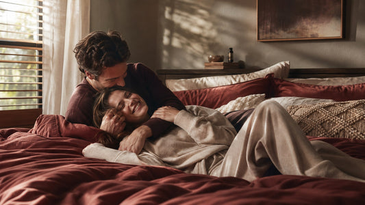 A couple close together in a warm sunlit bedroom, Superman position