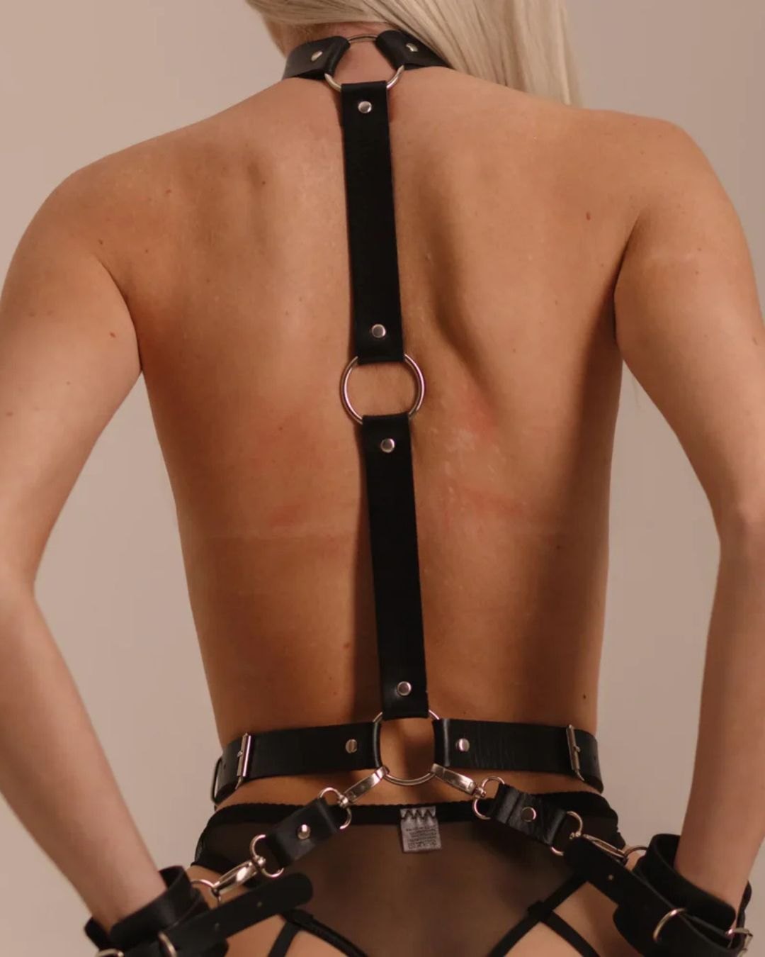 Black vegan leather body harness with metal hoops and handcuffs, photo 5